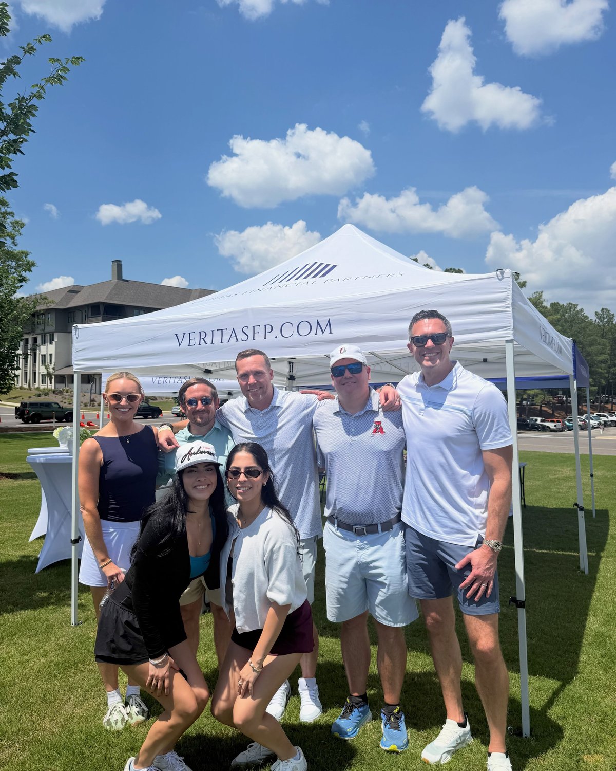 The Veritas team under a branded tent at a golf event.