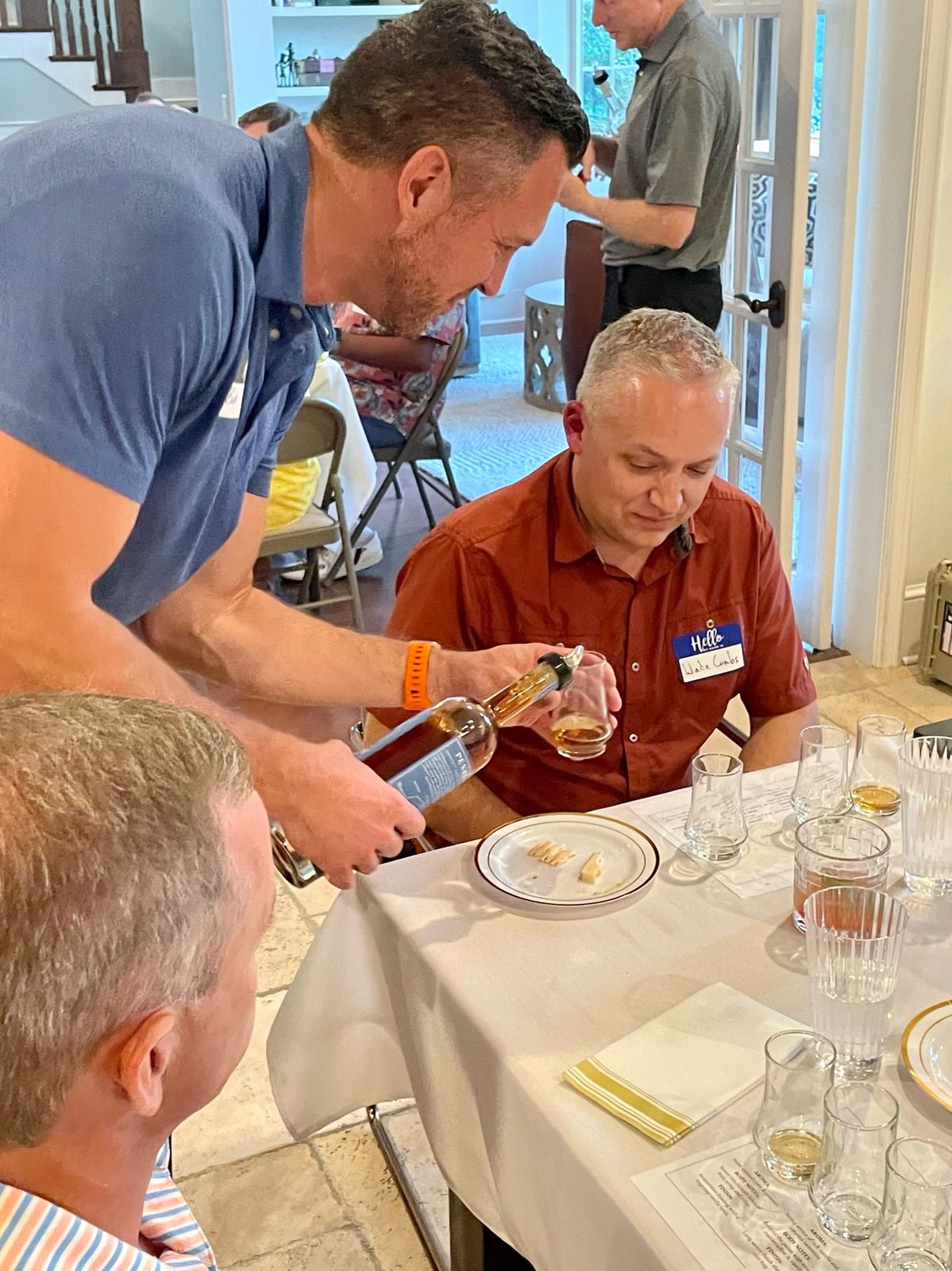 A pour being served to a seated guest during a tasting.